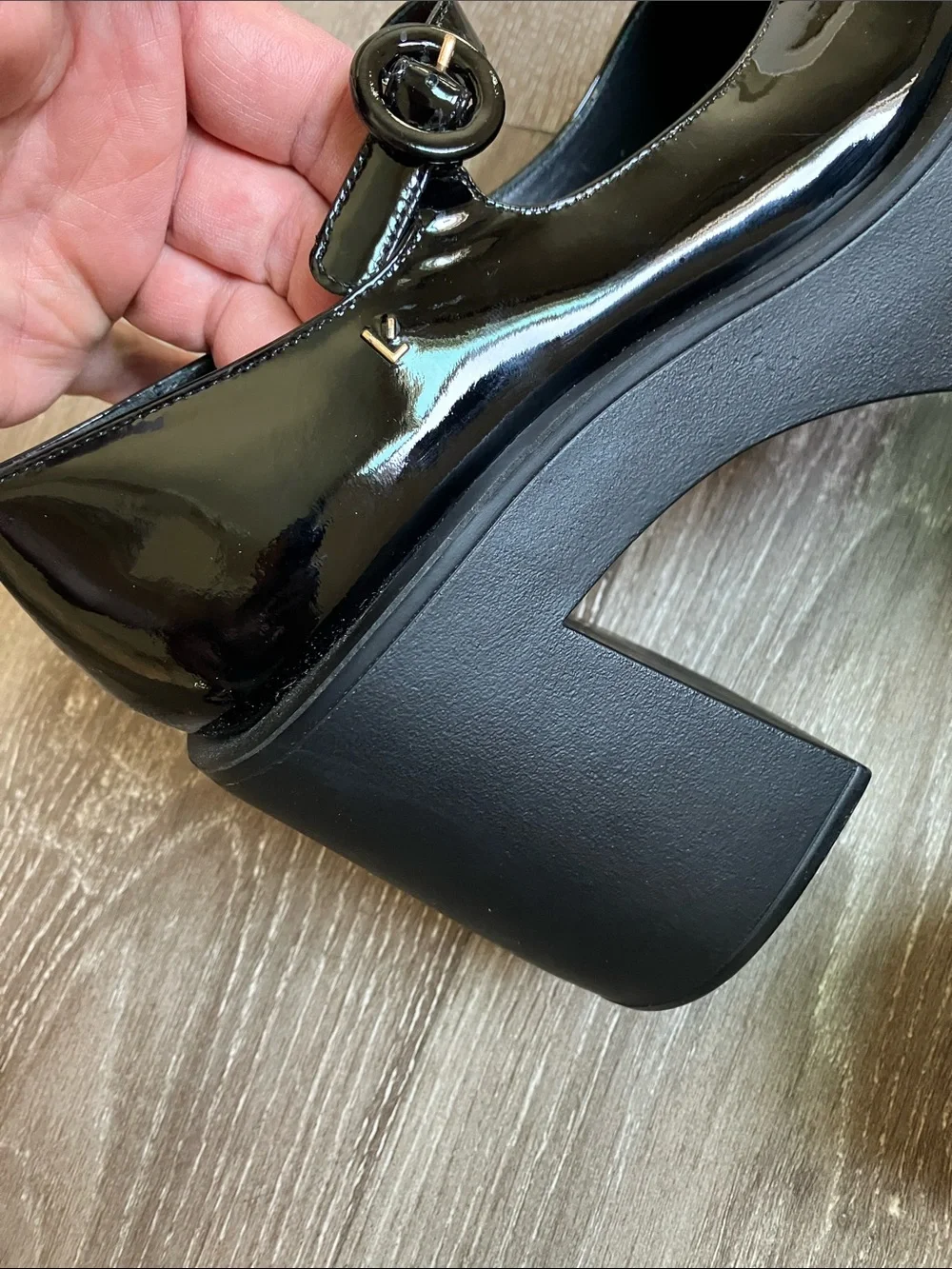 Larroude Olivia Platform Pumps in glossy black patent leather.